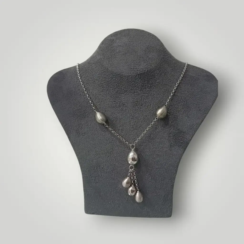 Silver Necklace With Multiple Teardrop-Shaped Beads And A Drop Pendant. - View 2